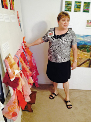 Ellen Lindner discussing red fabrics hung for inspiration