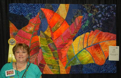 Ellen Lindner with her art quilt, Crotons.  AdventureQuilter.com