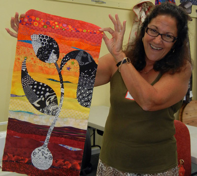 Carma with her "Grow with the Flow" quilt.  Class taught by Ellen Lindner, AdventureQuilter.com