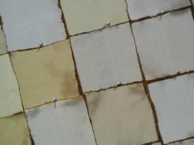 Image - sqaures of cream colored silk fabrics