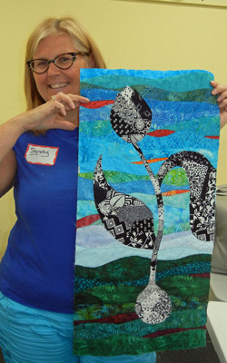 Sandy with her "Grow with the Flow" quilt.  Class taught by Ellen Lindner, AdventureQuilter.com