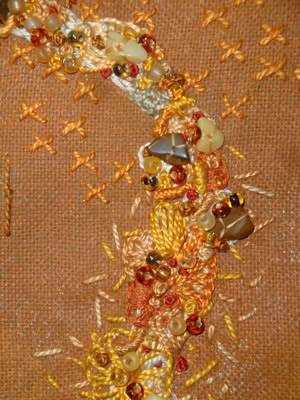 Images - embroidery and beads against rust fabric