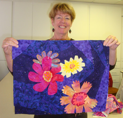 Cass showing off her Design Your Own Nature Quilt project,taught by Ellen Lindner, AdventureQuilter.com