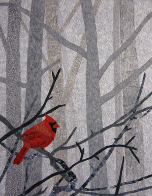 Image - red bird among gray branches