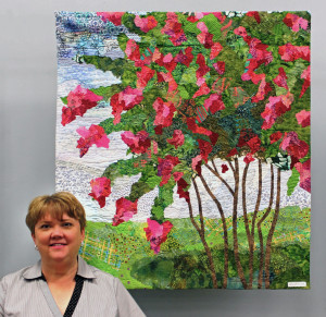 Ellen Lindner with her fabric collage, Summer in the South.  AdventureQuilter.com/blog