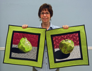 Marge Lehrer with two projects started in a class taught by  Ellen Lindner.  AdventureQuilter.com/blog