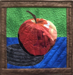 3D looking apple made in Ellen Lindner's Double Reverse Applique class. AdventureQuilter.com