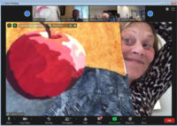 A student shows off her work in Ellen Lindner's Double Reverse Applique class (via Zoom.) AdventureQuilter.com